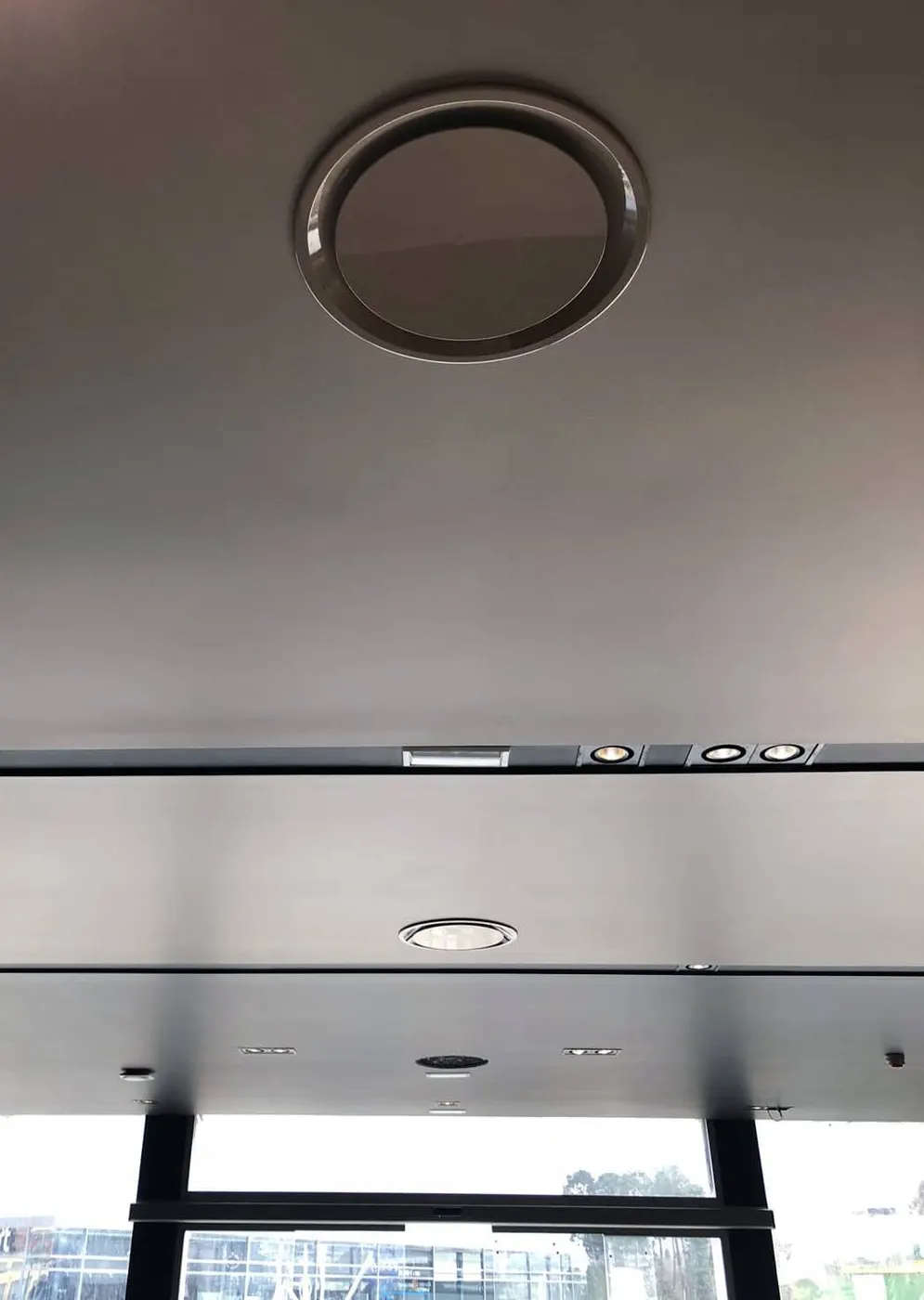 DSO Architectural Aluminum Round Plaque Diffuser installed in a dealership's ceiling